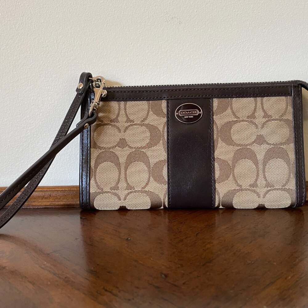 COACH brown and taupe convertible wristlet / wallet with signature “C” pattern